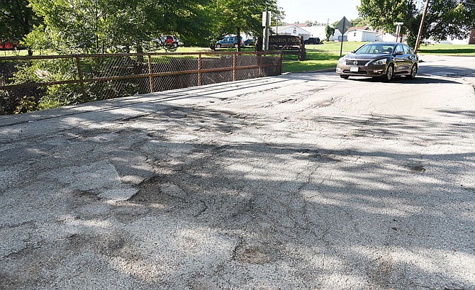 The Ohio Street bridge is a patchwork of asphalt and the weight limit on it, which is located one block south of Missouri Boulevard, has been changed from 15 tons to 5 tons. 