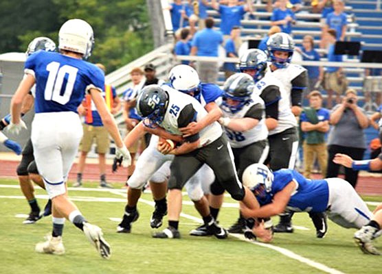 South Callaway senior running back Bradyn Belcher drags a pair of Hermann defenders during the Bulldogs' 21-6 win against the Bearcats last month in Hermann.