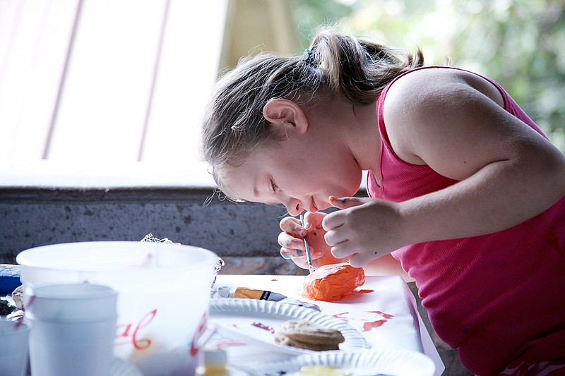 Sally Ince/ News Tribune 
Rylee Arten, 8, paints her rock orange September 15, 2018 during the JC Rockfest at McClung Park. This was the first year JC Rocks held the free event for families to enjoy. The group provided all the materials for participants to paint rocks, enjoy food and held raffle with fun prizes for children and gift certificates for a family dinner. 