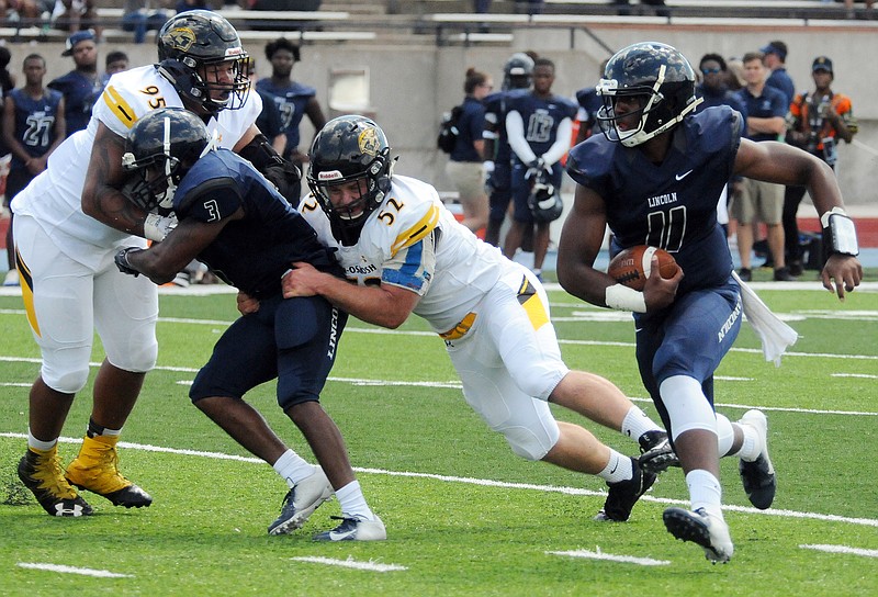 Mark Wilson/News Tribune
Lincoln (11) rushes in football as they host Wisconsin-Oshkosh at Reed Stadium Saturday.