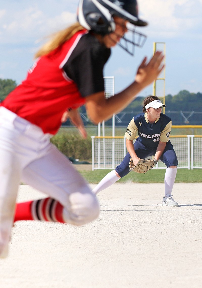 Jason Strickland/News Tribune
Helias third baseman Sophia Carr fields a ground ball as Jefferson City's Olivia Wallace sprints to first base during Saturday's Capital City Invitational championship game at 63 Diamonds. 