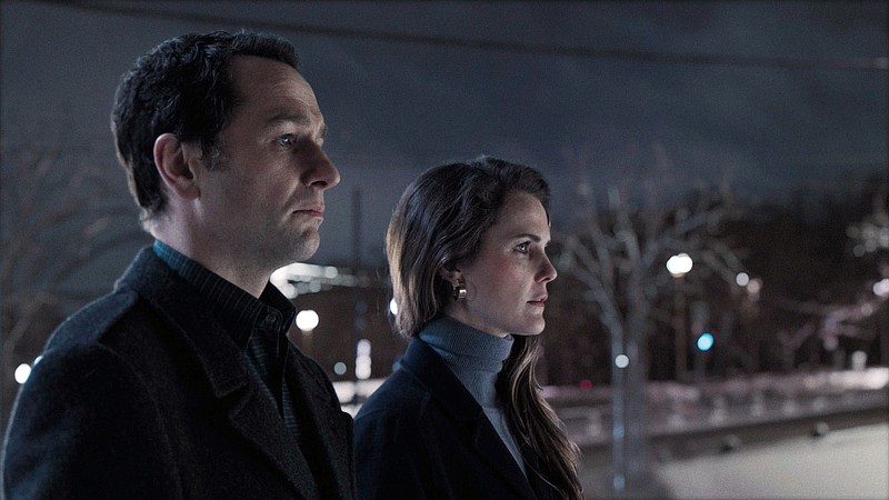 This image released by FX shows Matthew Rhys, left, and Keri Russell in a scene from "The Americans." The program iss nominated for an Emmy on Thursday for outstanding drama series. The 70th Emmy Awards will be held on Monday, Sept. 17. Russell and Rhys are also nominated for outstanding actress and actor in a drama series. (FX via AP)