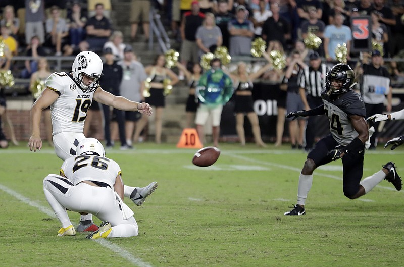 Missouri place kicker Tucker McCann (19) kicks a game-winning, last-second field goal from the hold of Corey Fatony against Purdue in the second half of an NCAA college football game in West Lafayette, Ind., Saturday, Sept. 15, 2018. Missouri defeated Purdue 40-37. (AP Photo/Michael Conroy)