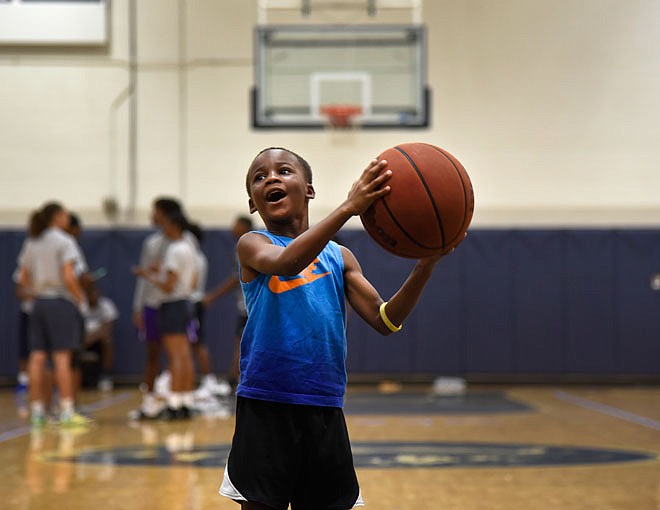 Aiden Beard, in kindergarten, shoots a basketball Friday at the Cole County Youth Day. 