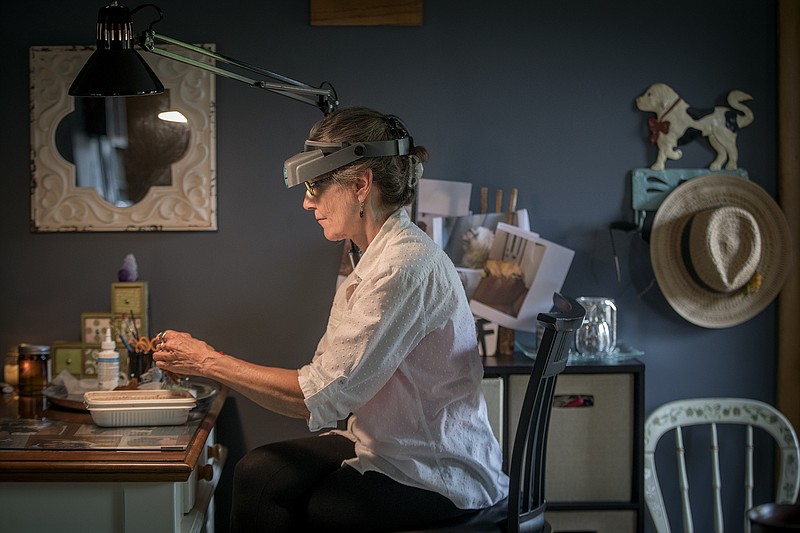 Lucy Francis works on creating a miniature replica of a dog from an order at her home, on August 6, 2018, in Hastings, Minn. Her miniature art pieces sell for $300 to $2,400, with some work ending up in the hands of celebrities such as Martha Stewart and Shirley MacLaine. (Elizabeth Flores/Minneapolis Star Tribune/TNS)