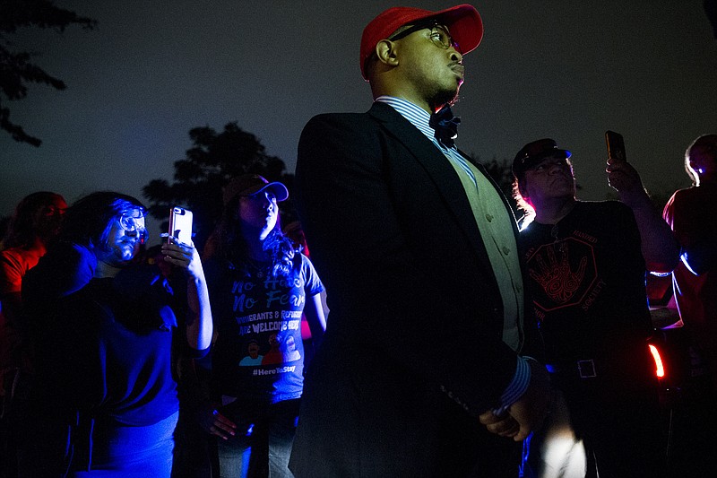 Jamil Tucker listens to Dominique Alexander as they march to the Dallas Police Association Office on Monday, Sept. 10, 2018 in Dallas, Texas. (Shaban Athuman/Dallas Morning News/TNS)