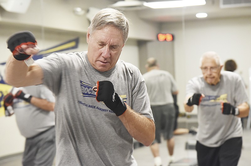 Julie Smith/News Tribune
Bob Knight can throw a punch and does so multiple times while taking part in the Rock Steady Boxing program at Sam B. Cook Healthplex at Capital Region Medical Center's Southwest Campus. In the background, putting his body into it is Jim Huhmann. 