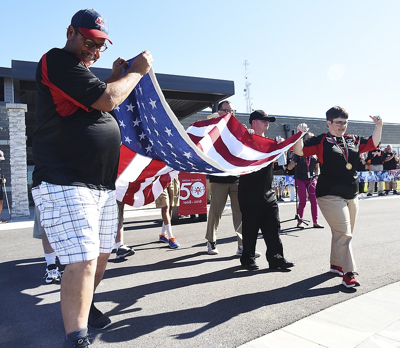 Julie Smith/News Tribune
Special Olympics athletes proudly carry the American flag to the pole to be raised for the first time. Special Olympics Missouri (SOMO) hosted a ribbon cutting ceremony Thursday at their new Training for Life campus located near the city's southern limits. 