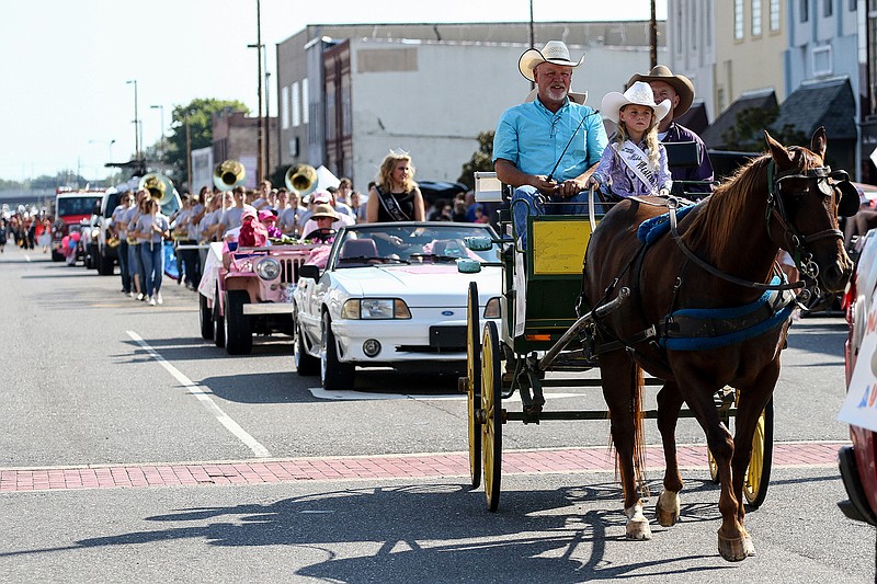 Cars, horses and trailers filled with people travel down East Broad Street on Saturday during the Four States Fair Parade in downtown Texarkana. The parade kicked off for the Four States Fair, which will run until Sept. 23.