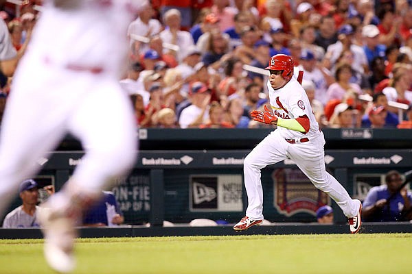 Yairo Munoz runs for home to score on a single hit by Cardinals teammate Jedd Gyorko during the fourth inning of Sunday night's game against the Dodgers at Busch Stadium.