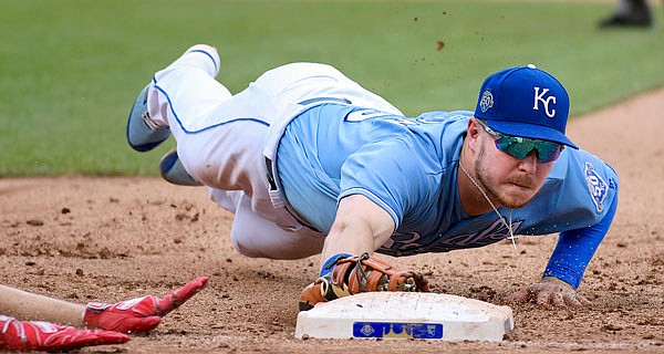 Royals first baseman Ryan O'Hearn dives to first base to force out Max Kepler of the Twins during the fourth inning of Sunday afternoon's game at Kauffman Stadium.