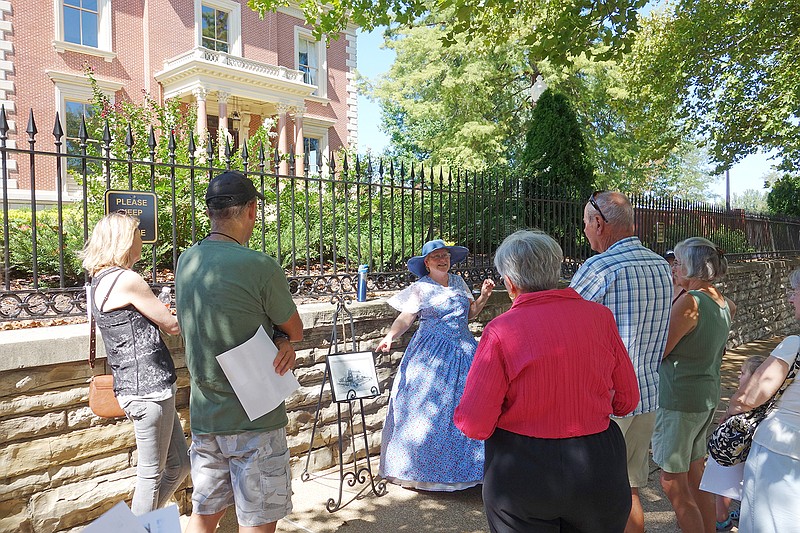 Volunteers dressed in period costumes gave presentations Sunday to visitors who came out to enjoy the Cole County Historical Society's, "A Walk Through Time," on Madison and State streets.