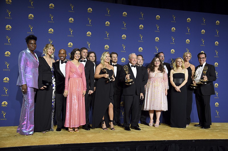 Lorne Michaels, center, and the cast and crew from "Saturday Night Live" pose backstage with the award for outstanding variety sketch series at the 70th Primetime Emmy Awards on Monday, Sept. 17, 2018, at the Microsoft Theater in Los Angeles. (Photo by Jordan Strauss/Invision/AP)