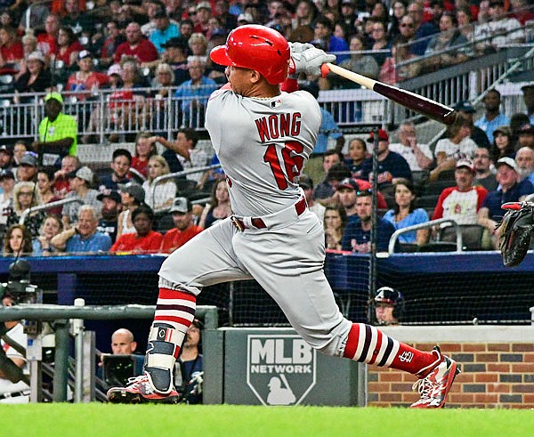 Kolten Wong of the Cardinals hits a line drive to right field for a two-run double during the first inning of Monday's game against the Braves in Atlanta.