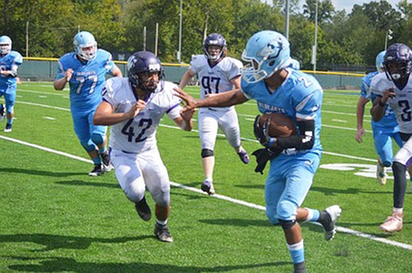 Westminster senior quarterback Trent White gives a stiff-arm to Iowa Wesleyan junior linebacker Marco Ventura during the Blue Jays' 35-10 win against the Tigers in Saturday's home and UMAC opener. White ran for three touchdowns and also threw for a score.