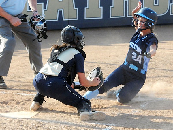 Helias catcher Riley Heckenkamp tags outs Mae Cross of Father Tolton during the first inning of Monday's game at the American Legion Post 5 Sports Complex.