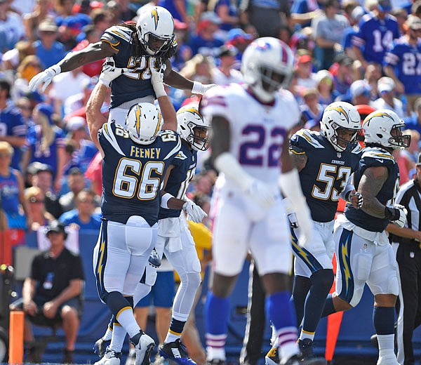 Vontae Davis of the Bills (center) walks away as Melvin Gordon of the Chargers celebrates his touchdown during Sunday's game in Orchard Park, N.Y.