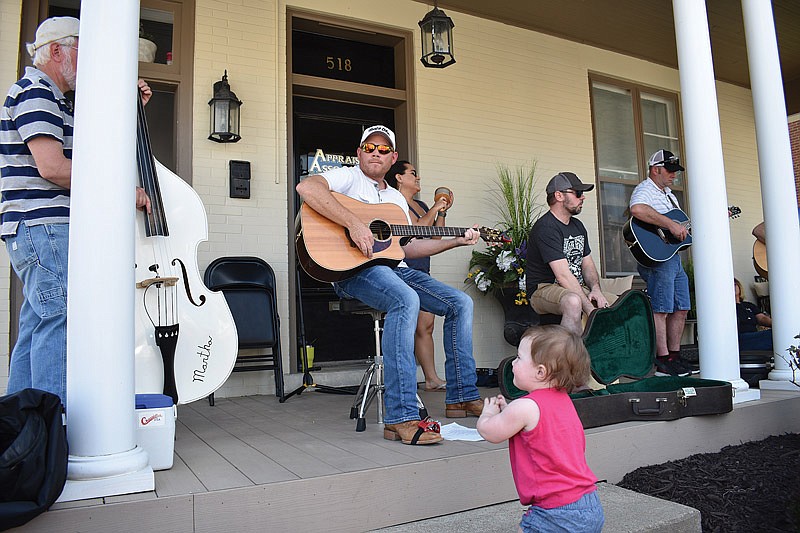 
Fifteen-month-old Avery Senzee dances to the sound of Robby Bax at 518 E. Capitol Ave. during Jefferson City's first Porchfest May 6, 2018. Her father, James, said she loves dancing to live music.