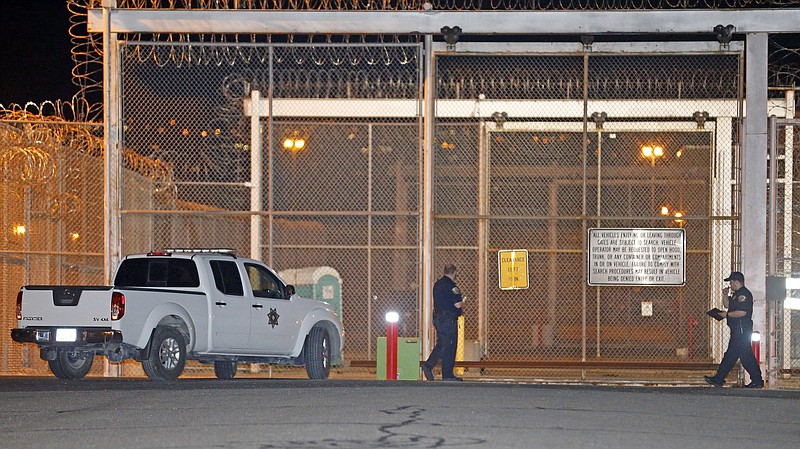 Correctional officers stand outside a gate at the Utah State Correctional Facility Wednesday, Sept. 19, 2018, in Draper, Utah. Wanda Barzee, a woman who helped kidnap Elizabeth Smart when she was a teenager and stood by as the girl was sexually assaulted, was released from prison Wednesday after 15 years in custody. Barzee, 72, left the Utah state prison in the Salt Lake City suburb of Draper, spokeswoman Kaitlin Felsted said in a statement that did not provide details about Barzee's destination. (AP Photo/Rick Bowmer)