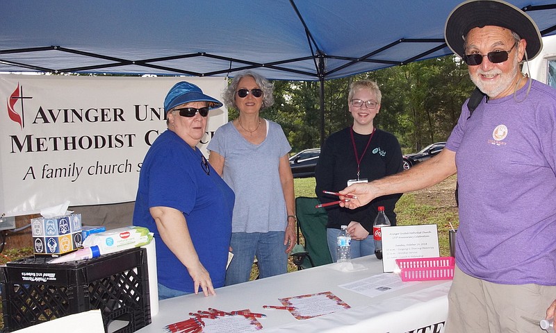 Avinger Methodist Church gave out free ice-cold water and pens Saturday during Avinger's wine festival. The church will celebrate its 175th anniversary Oct. 16. Members serving Joe Ball are, from left, Jane Yarbrough, Nancy Walker and Shelby Neville.