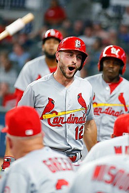 Paul DeJong celebrates a two-run home run in the dugout with Cardinal teammates during the fourth inning of Tuesday night's game against the Braves in Atlanta.