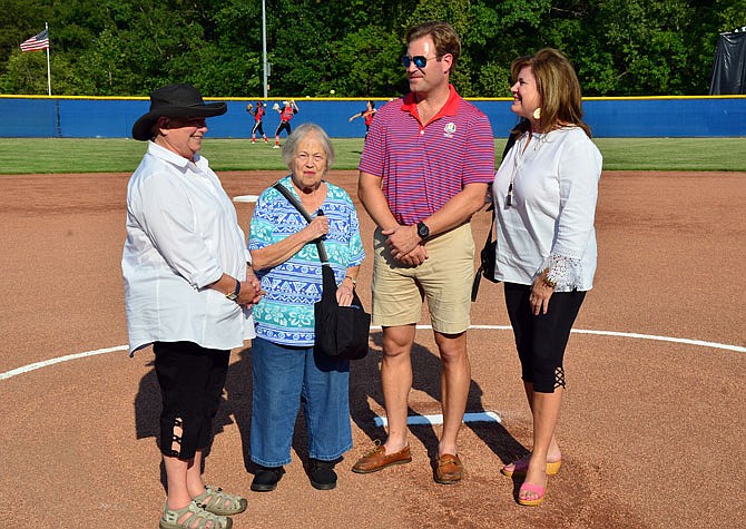 The family of Carl Vogel gather on the pitcher's mound Tuesday at the ribbon-cutting for the Carl M. Vogel Field, formerly Cosmo Field. From left, are Carl Vogel's sisters Edie Vogel and Rose Mengwasser, his son Jake and Carl Vogel's widow, Kim.