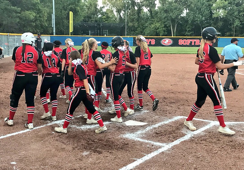 Jefferson City Lady Jays congratulate Reece DeSimone Tuesday, Sept. 18, 2018, after she hit a solo home run straightaway to center field, extending the Lady Jays' lead to 4-1 on the way to a 5-4 win over Hickman at Vogel Field.