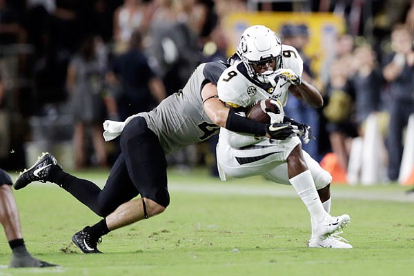 Missouri wide receiver Jalen Knox is tackled by Purdue safety Jacob Thieneman during Saturday night's game in West Lafayette, Ind.