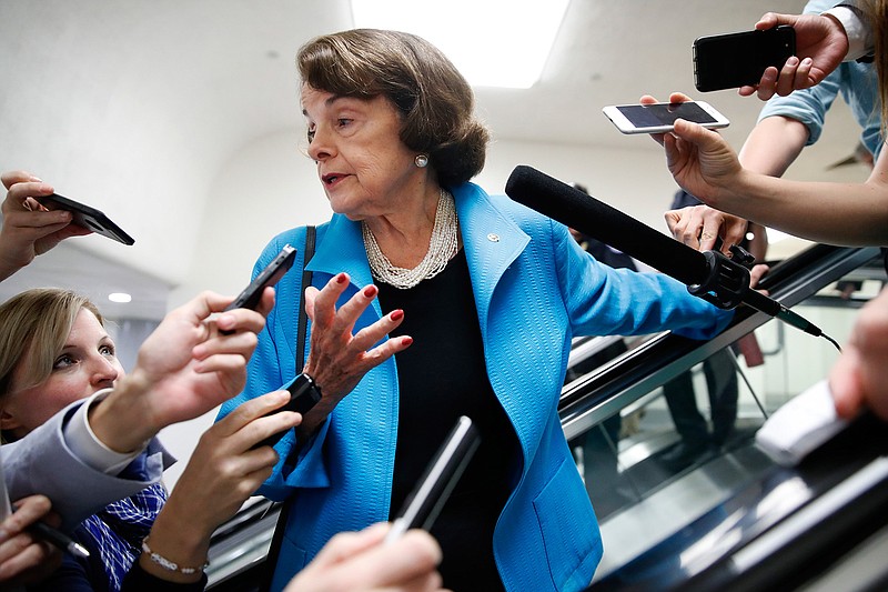 Sen. Dianne Feinstein, D-Calif., is surrounded by reporters as she arrives for a vote, Tuesday, Sept. 18, 2018, on Capitol Hill in Washington. (AP Photo/Jacquelyn Martin)