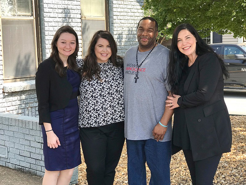 In this photo provided by the law firm Lassiter and Cassinelli, John Brown, second from right, poses with Midwest Innocence Project investigator Blair Johnson, MIP attorney Rachel Wester, and attorney Erin Cassinelli after Brown was released from prison on Wednesday, Sept. 19, 2018, in Little Rock, Ark. In August, a judge overturned Brown's 1992 conviction for the murder and robbery of an elderly woman. The state is appealing the judge's decision and Brown could still be retried. (Jene Louviere/Lassiter and Cassinelli via AP)