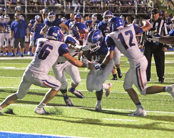 California's Alex Meisenheimer (16) and Adrian Contreras (12) try to bring down a Boonville ball carrier short of the goal line in last Friday's game at Boonville.