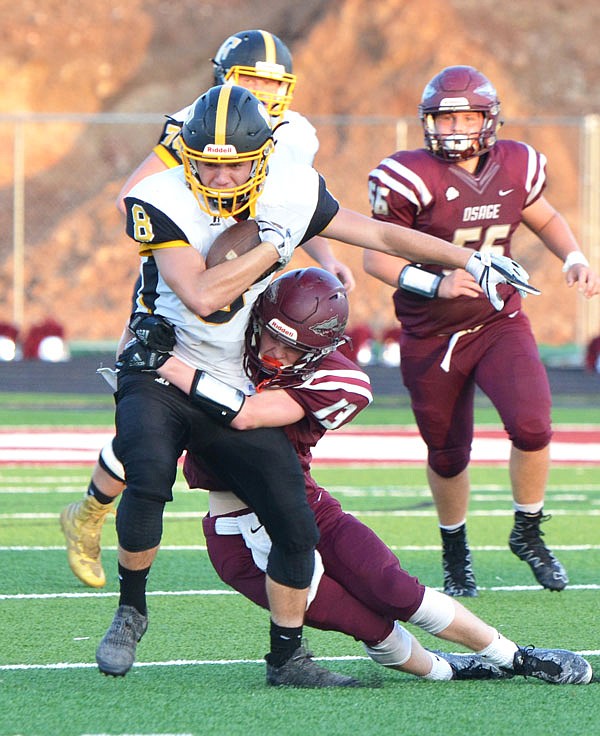 Fulton's Justin Leake tries to escape a tackle by School of the Osage's Jack Dulle during a game last month at Osage Beach.