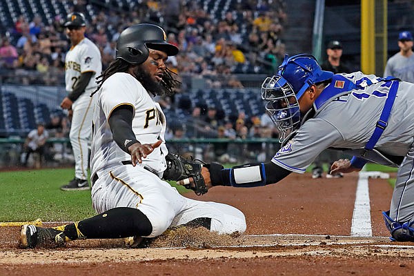 Royals catcher Salvador Perez tags out Josh Bell of the Pirates in the first inning of Wednesday's game in Pittsburgh.