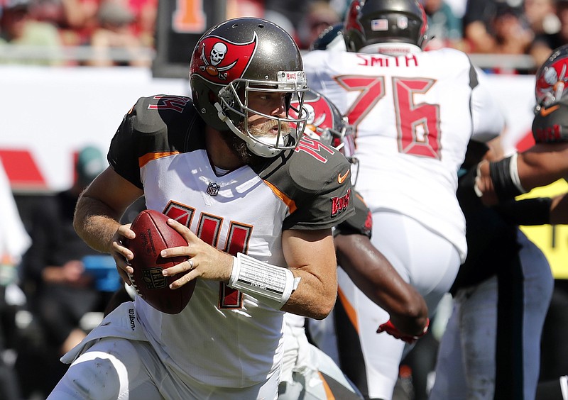 In this Sunday, Sept. 16, 2018, file photo, Tampa Bay Buccaneers quarterback Ryan Fitzpatrick (14) rolls out during the second half of an NFL football game against the Philadelphia Eagles in Tampa, Fla. Miami Dolphins rookie safety Minkah Fitzpatrick wants to trademark his nickname but says he'd be happy to share it with Buccaneers quarterback Ryan Fitzpatrick. Both go by "FitzMagic."  (AP Photo/Mark LoMoglio, File)