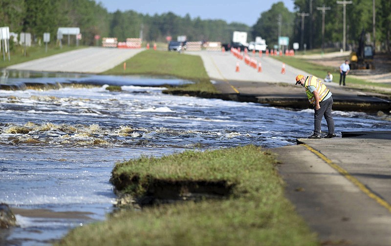 Flooding from Sutton Lake has washed away part of U.S. 421 in New Hanover County just south of the Pender County line in Wilmington, N.C., Friday, Sept. 21, 2018.   (Matt Born /The Star-News via AP)