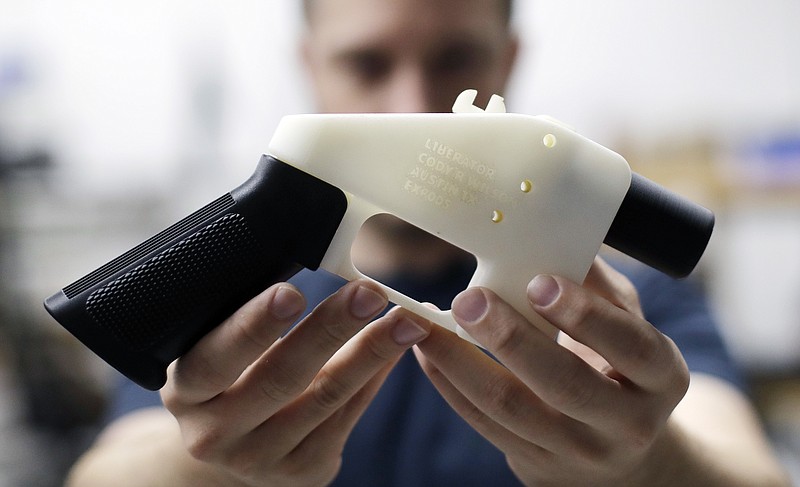 In this Aug. 1, 2018, file photo, Cody Wilson, with Defense Distributed, holds a 3D-printed gun called the Liberator at his shop in Austin, Texas.  Police allege in an affidavit filed Wednesday, Sept. 19, that Wilson had sex with an underage girl and paid her $500 afterward.  Austin police Detective Shaun Donovan wrote in a request for a warrant to arrest Wilson on a sexual assault charge. The court filing doesn't say how old the girl is, but Texas' age of consent is 17.  (AP Photo/Eric Gay, File)