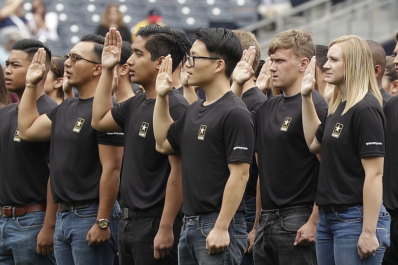 In this June 4, 2017, file photo. nNew Army recruits take part in a swearing in ceremony before a baseball game between the San Diego Padres and the Colorado Rockies in San Diego. The Army has missed its recruiting goal for the first time in more than a decade. Army leaders tell The Associated Press they signed up about 70,000 new troops for the fiscal year that ends Sept. 30, 2018. (AP Photo/Gregory Bull, File)