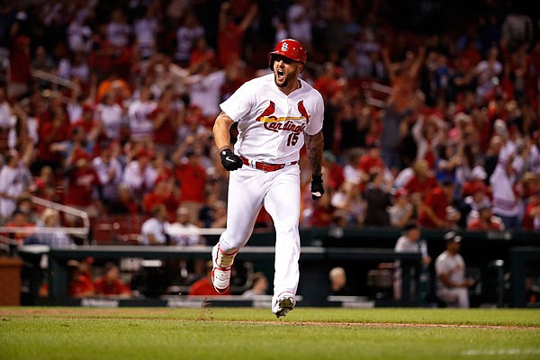 Matt Adams celebrates after hitting a two-run double in the eighth inning of Friday night's game against the San Francisco Giants in St. Louis.