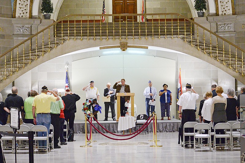 Guests, veterans and speakers stand for the ceremonial playing of Taps on Friday during the POW/MIA Recognition Day ceremony at the Capitol Rotunda. The event brings awareness and recognizes all POW's over the years.