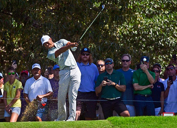 Tiger Woods tees off to the third hole during Friday's second round of the Tour Championship in Atlanta.