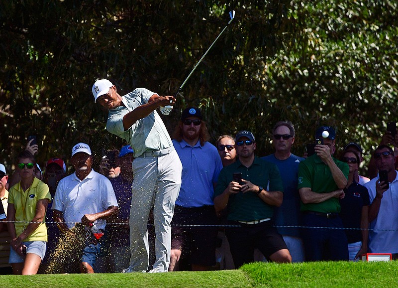 Tiger Woods tees off to the third hole during the second round of the Tour Championship golf tournament Friday, Sept. 21, 2018, in Atlanta. (AP Photo/John Amis)