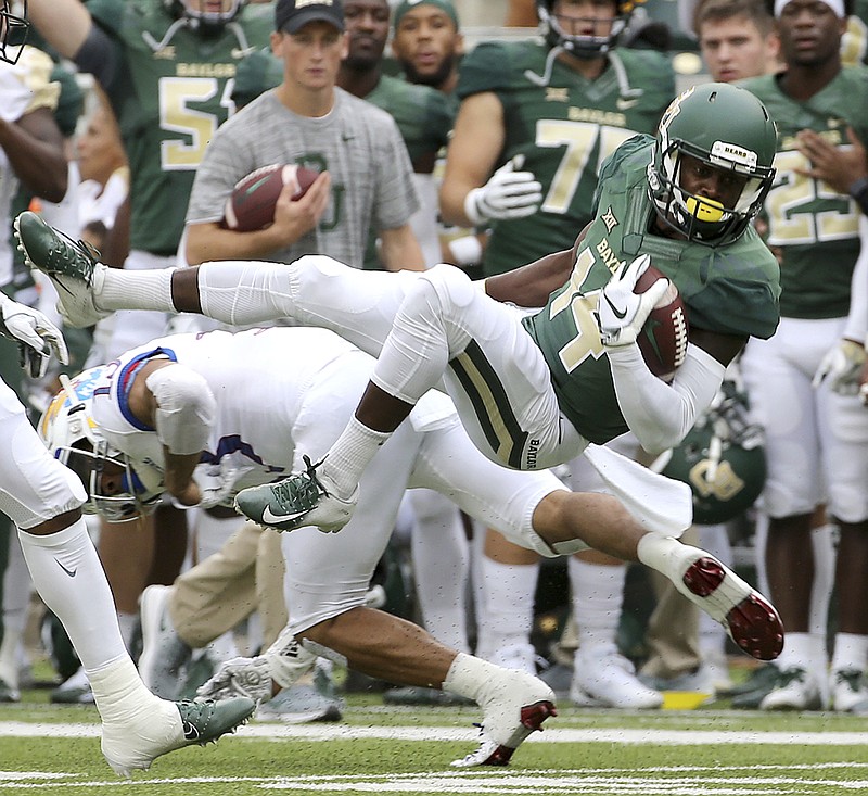 Baylor wide receiver Chris Platt (14) is upended by Kansas cornerback Hasan Defense (13) during the first half of an NCAA college football game, Saturday, Sept. 22, 2018, in Waco, Texas. (Jerry Larson/Waco Tribune Herald, via AP)