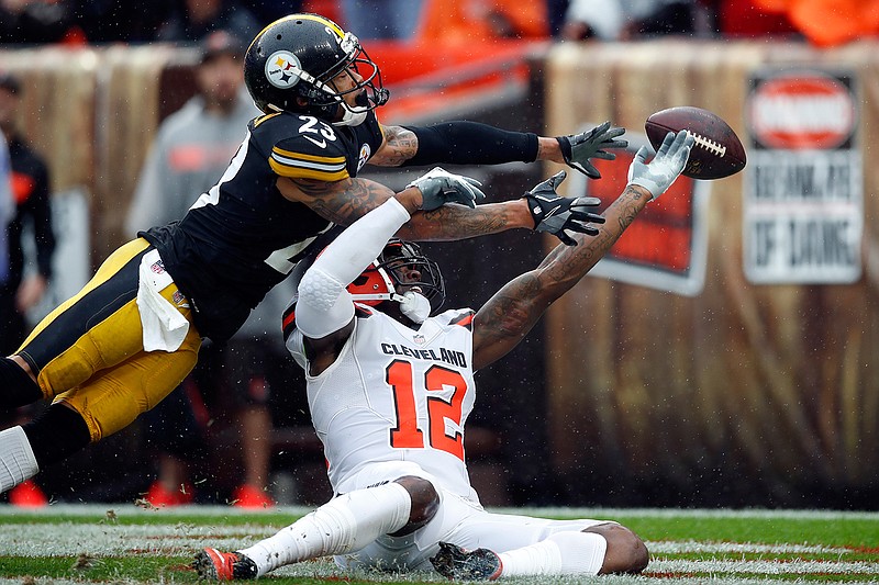 In this Sunday, Sept. 9, 2018, file photo, Cleveland Browns wide receiver Josh Gordon (12) and Pittsburgh Steelers defensive back Joe Haden (23) reach for the ball during an NFL football game in Cleveland. In a slopfest of an opener, the Steelers and Browns drew 21-21. (Jeff Haynes/AP Images for Panini, File)