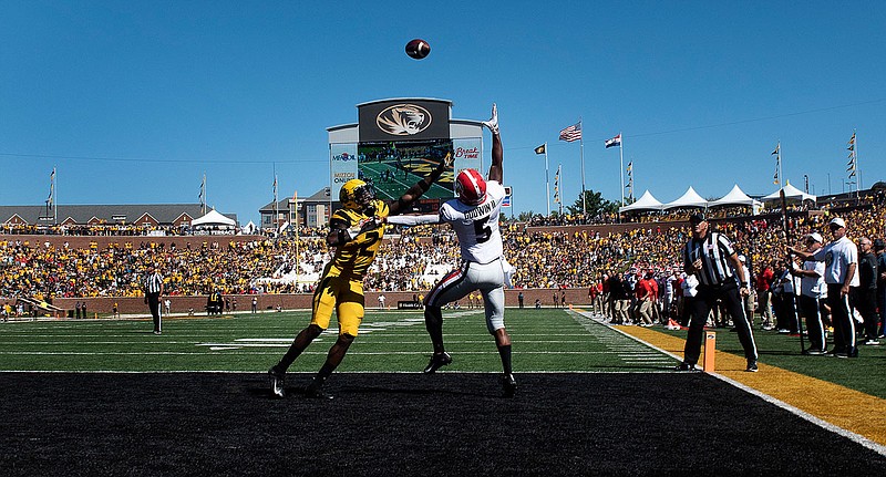 Georgia wide receiver Jayson Stanley reaches to catch the ball past Missouri defensive back DeMarkus Acy during Saturday's game at Faurot Field.