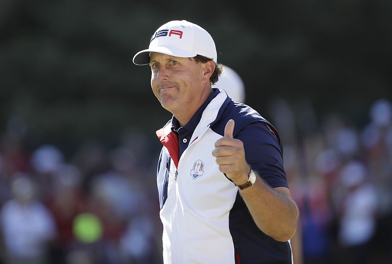 In this Oct. 2, 2016, file photo, United States' Phil Mickelson gives a thumbs-up after winning the 15th hole during a singles match at the Ryder Cup golf tournament at Hazeltine National Golf Club in Chaska, Minn. Mickelson sets a record at next week's Ryder Cup with his 12th consecutive appearance. (AP Photo/David J. Phillip, File)