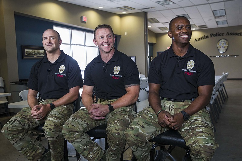 Austin SWAT officers, Leighton Radtke, 34, from left, Sgt. Brannon Ellsworth, 45, middle, and Michael Ridge, 36, right, who were involved in the final scene of the Austin bombing case. The officers are interviewed at the Austin Police Association headquarters on Wednesday, Sept. 12, 2018, in Austin, Texas. (Amanda Voisard/Austin American-Statesman via AP)