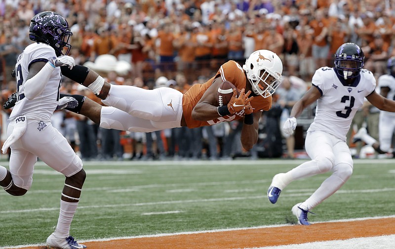 Texas wide receiver Collin Johnson (9) makes a diving catch for a touchdown between TCU defenders Jeff Gladney (12) and TCU safety Markell Simmons (3) during the second half of an NCAA college football game, Saturday, Sept. 22, 2018, in Austin, Texas. (AP Photo/Eric Gay)