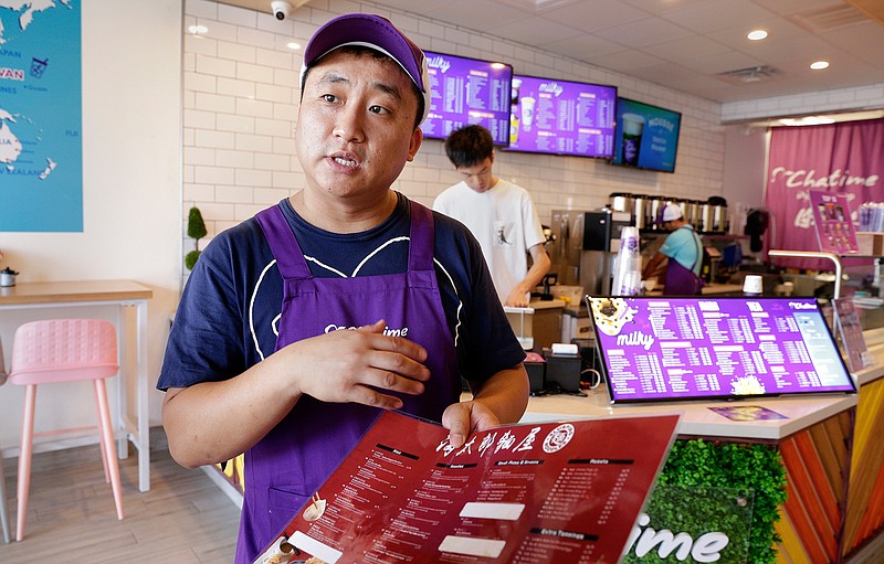 Ray Xu talks about his restaurant, Chatime, on Sept. 17 in the newly opened Katy Asian Town shopping center in Katy, Texas.