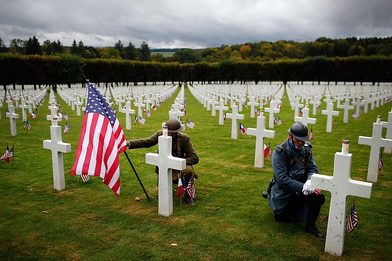 Men in World War I military uniforms pose Sunday, Sept 23, 2018, in the Meuse-Argonne cemetery, northeastern France, during a remembrance ceremony. The ceremony commemorated the 1918 Meuse-Argonne offensive, America's deadliest battle ever, which cost 26,000 lives but helped bring an end to World War 1.