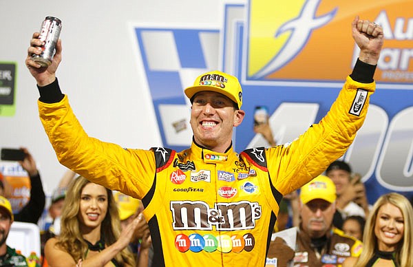 Kyle Busch celebrates winning the NASCAR Cup Series race in victory lane Saturday at Richmond Raceway in Richmond, Va.